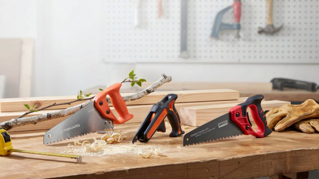 Compact hand saw comparison on a wooden workbench.