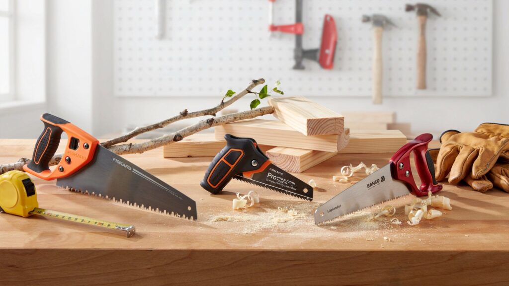 Compact hand saw comparison on a wooden workbench.